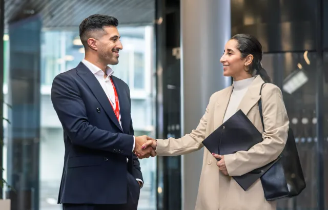 Man and woman shaking hands in a Circle K office